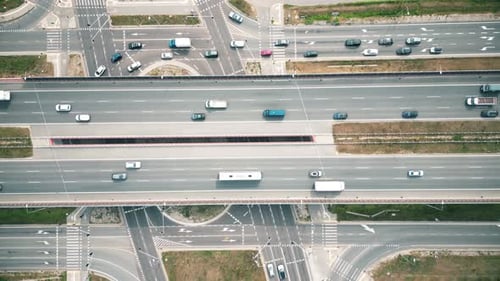 Urban veins: Drone footage over highway interlaced, reflecting non-stop flow of city traffic. Vehicu