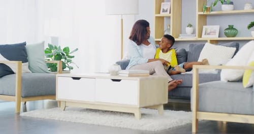 Woman and Child Sit Together in Sunny Living Room