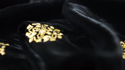 Luxurious black silken textile fabric velvet decorated with gold embroidery. Textile background.