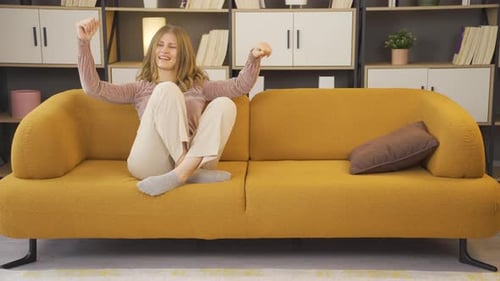 Fun woman dancing at home.