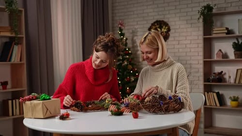 Smiling Women Making Christmas Wreaths Together