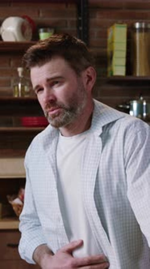 A Thoughtful Man in a Casual Setting Immersed in Contemplation While Cooking Breakfast