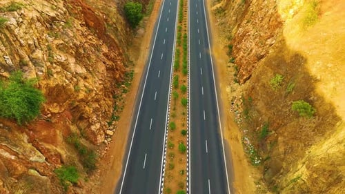 Canyon Like Mountains With a Highway In-between - Rising Upwards