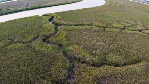 Drone view over winding tidal creeks and vast salt marshland along the South Carolina coast