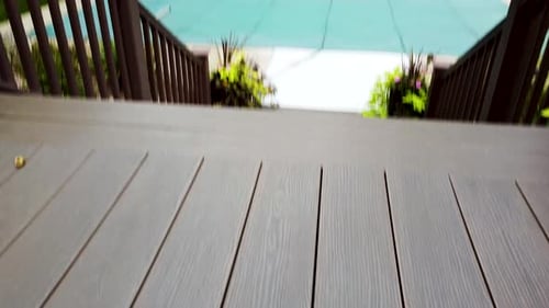 Tracking Shot Across Decking Towards a Swimming Pool