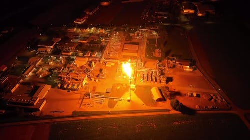 The Entire Facility is Bathed in Light as Gas Flaring Occurs - Drone Orbit Shot