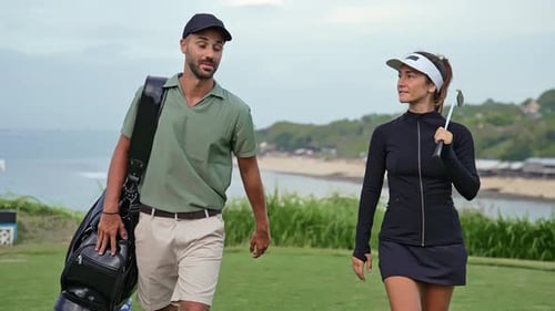 People Walking at Golf Course Look to Play Game with Ball and Carry Clubs in Bag