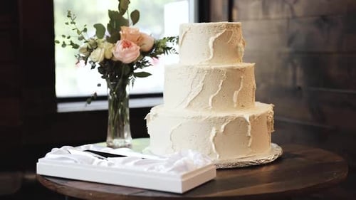 Elegant Wedding Cake Display with Floral Arrangement