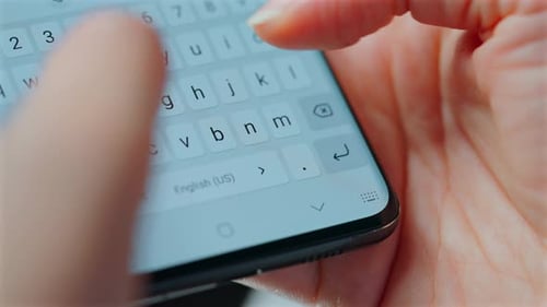 Fingers Typing on a Cell Phone Keyboard