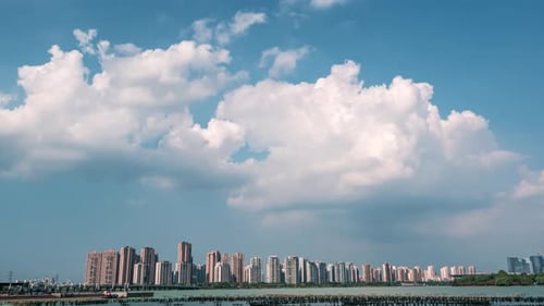 Time Lapse Cityscape at Daytime Blue Sky Clouds Pass Over Downtown Multistorey Buildings Lake and