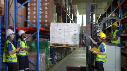 Warehouse worker controlling boxes in warehouse, Professional male warehouse worker moving cardboard