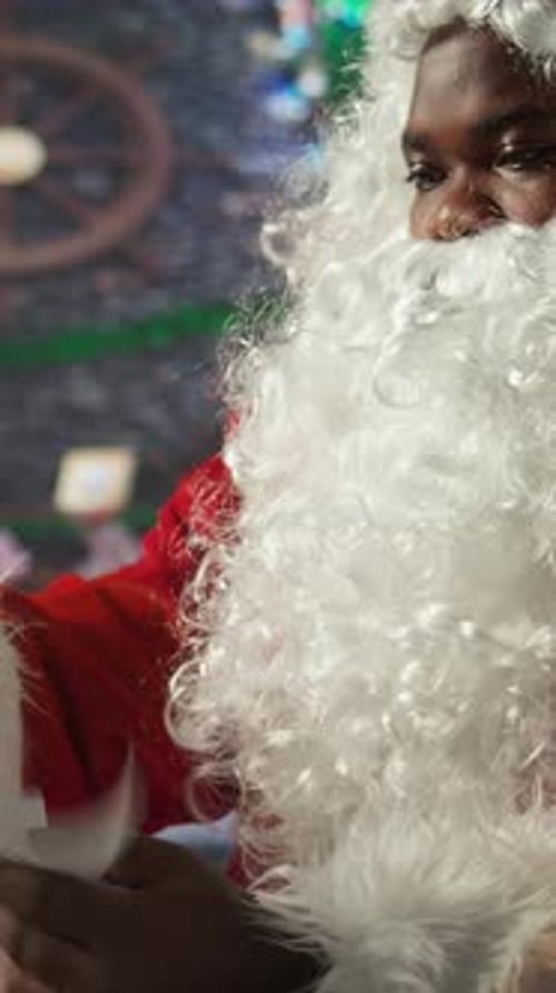 Man Dressed as Santa Claus Reads Scroll