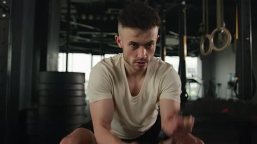 Strong Caucasian Sportsman Do Workout Fitness Man Exercising with Battle Rope in Dark Gym Active