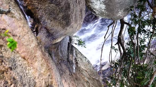 Idyllic mountain waterfall in Vietnam, relaxing nature landscape, vertical shot