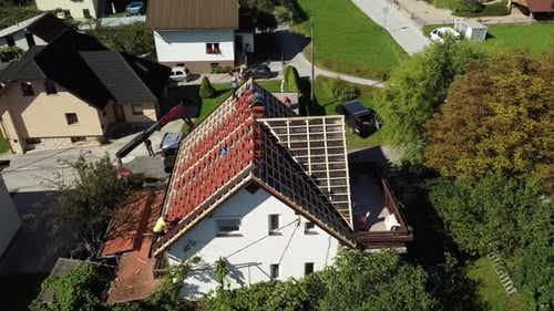 Roof maintenance person investment rooftop- Drone view of the toproof.