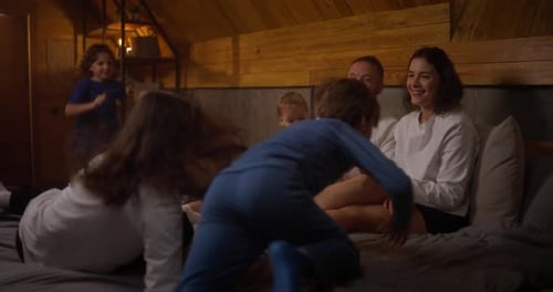 Happy Family Playing Together on Bed