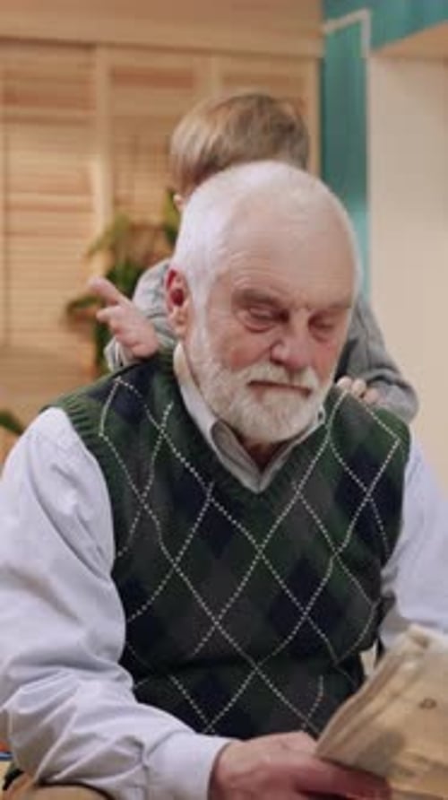 An Elderly Man is Enjoying His Time Reading a Newspaper in a Cozy and Peaceful Environment