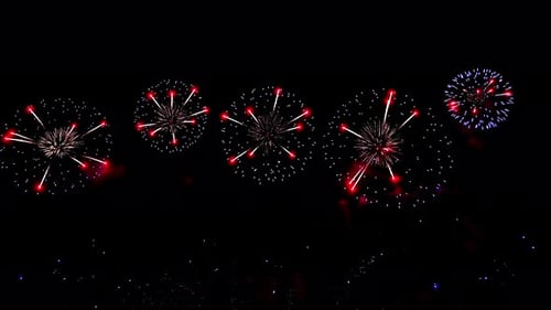 Bright Fireworks are Ignited Lighting Up the Dark Night Sky with Colorful Bursts and Explosions