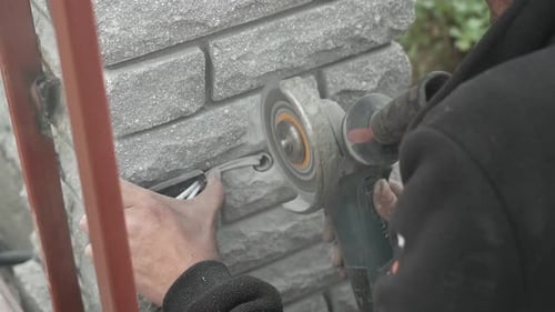 Worker use an Angle Grinder producing. Worker grinding metal. Remove rust. Bright sparks and flashes