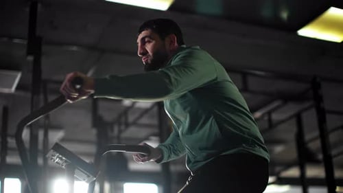 Man Using Exercise Bike for Cardio Workout Indoors