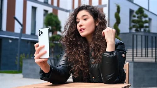 Woman Video Calling on Phone Outdoors