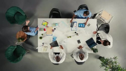 Top Down View of Physicians and Medics Gathered for Briefing Conference