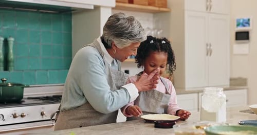 Child Baking Pie With Adult in Kitchen