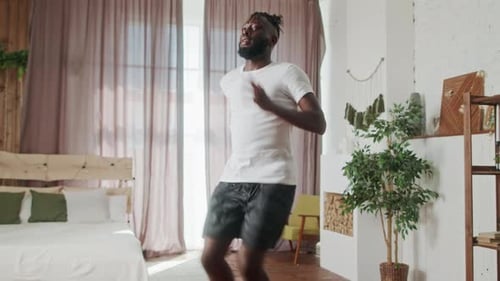 Young Man Jogging in Place Indoors