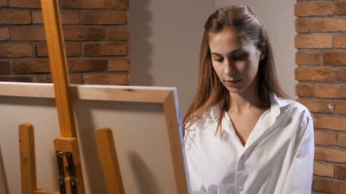 Pretty Artist in the Studio Draws a Picture