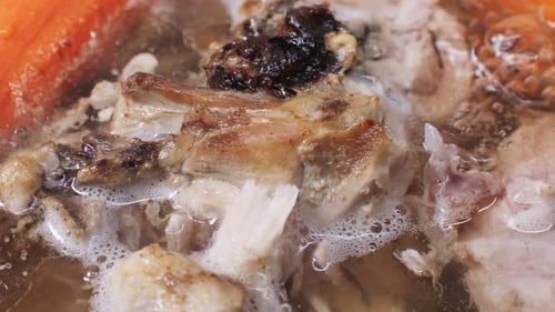 Simmering Bone Broth in a Bowl, Macro Shot