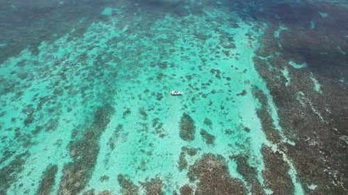 Aerial View of a Small Boat on the Turquoise Waters of Mauritius