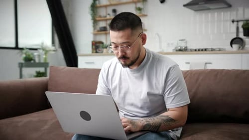 Young Adult Working on Laptop at Home
