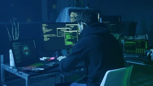 Person Typing Code at Computer at Night