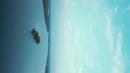the Camera Flies Over the River Towards a Small Uninhabited Island with Trees