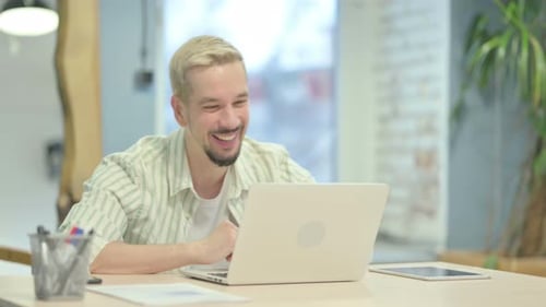 Young Man Working on Laptop, Video Calling