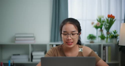 Young Woman Working on Laptop at Home