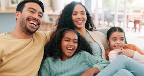 Happy Family Relaxing Together on Sofa at Home