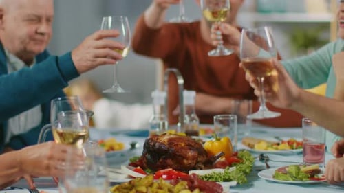 Family Celebrates with Food and Wine at Dinner Table