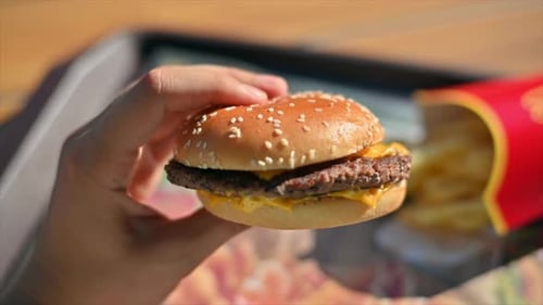 Close view of a burger hands on. Buns, meat and cheese