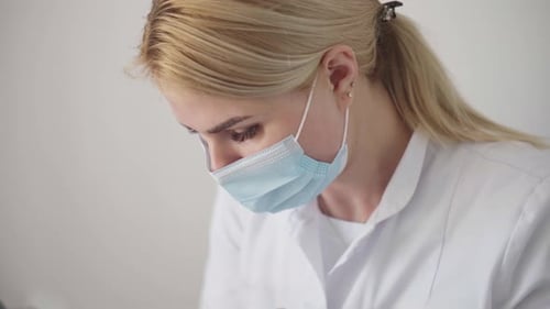 Woman in Mask and Lab Coat Close Up