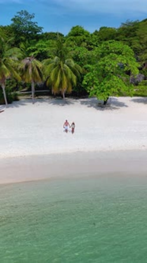 Enjoying a Romantic Stroll on the Pristine Sands of Koh Kham Island in Thailand