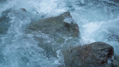 Water stream falling into river