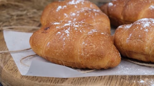 Powdered Croissants on a Cutting Board