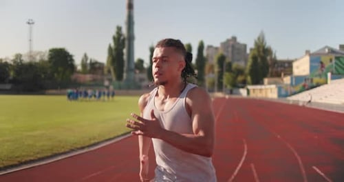 Young African American Runner Athlete Jogging at the Stadium