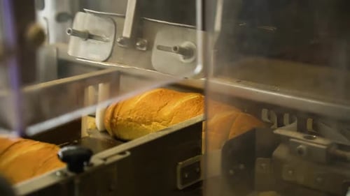 Automated Slicing Machine Cuts Loaves of Bread