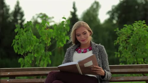 Girl Student Sitting on a Park Bench