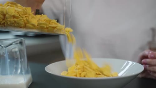 Corn Flakes Poured Into Bowl at Breakfast