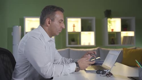 Adult Working on Laptop in Home Office