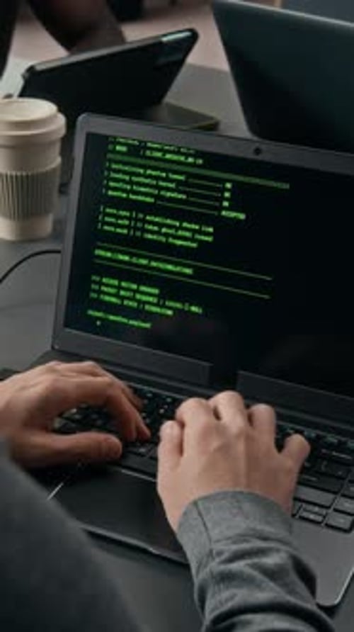 Typing Code on Laptop in Office Setting