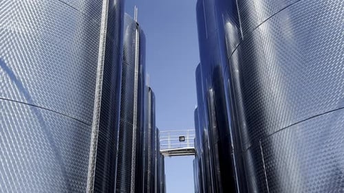 Industrial Storage Silos Under Clear Blue Sky in Modern Facility